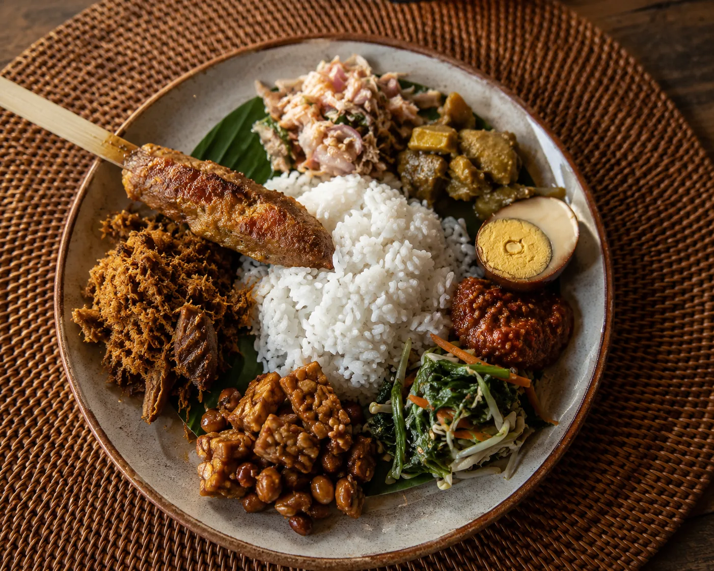 Close-up of sate lilit, sambal, and rice plated warung-style